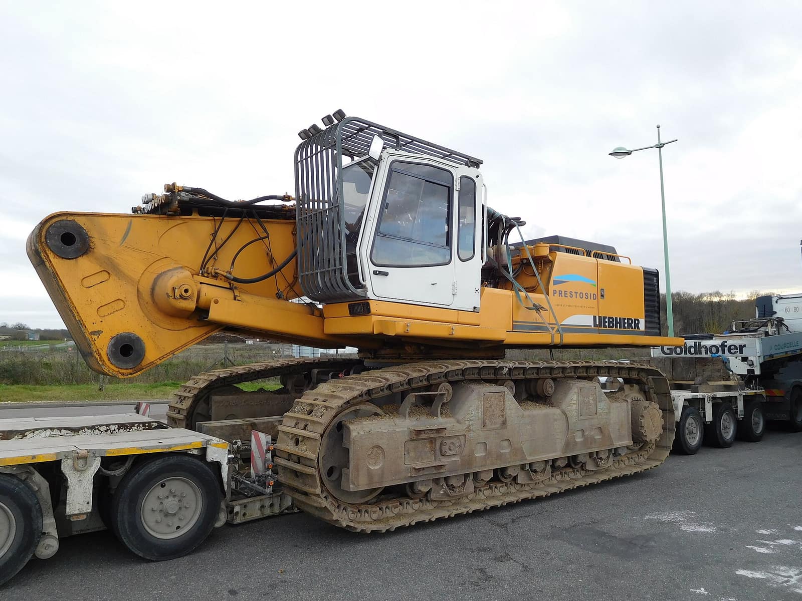A tracked excavator loaded on a low-bed trailer